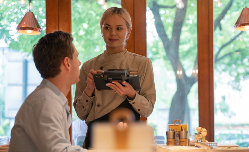 SUNMI V3 MIX handheld POS terminal used by server in restaurant