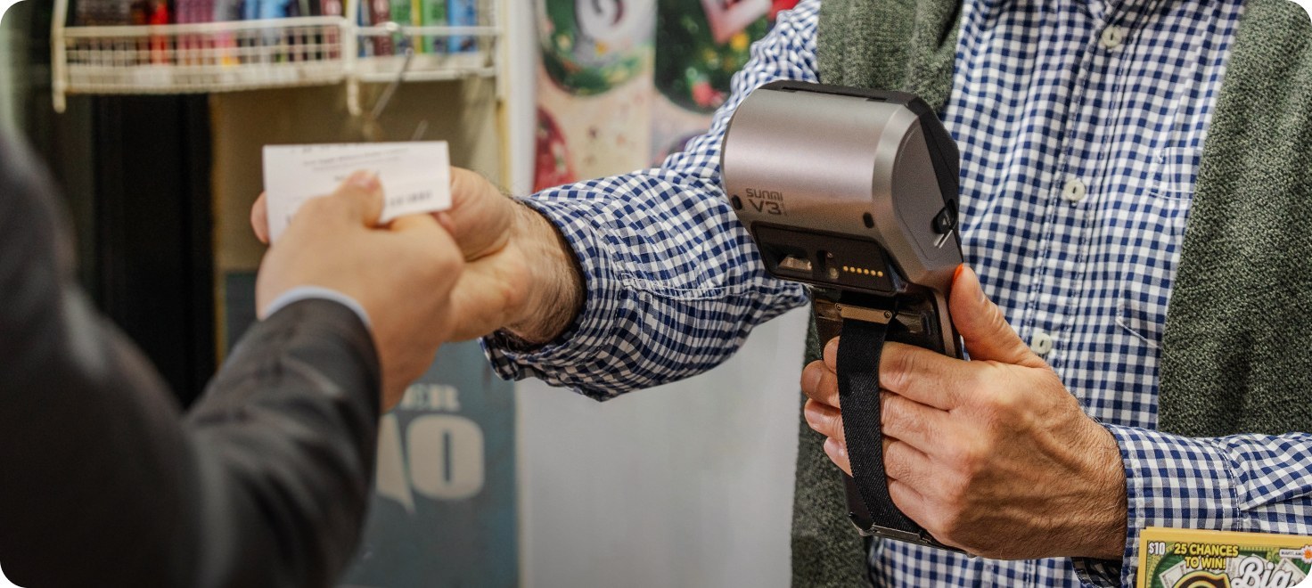 Store clerk handing receipt to customer with SUNMI V3 Plus